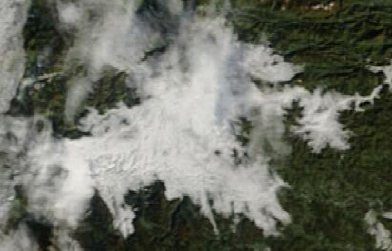 Satellite image of the Ljubljana basin: white is fog and cloud, dark is hills and fields.